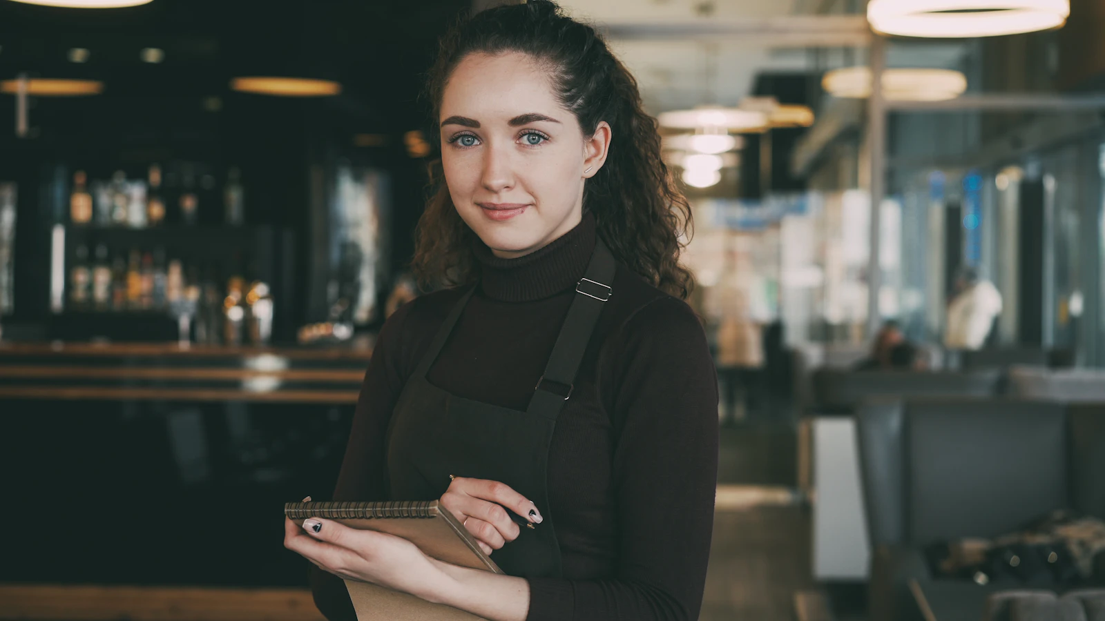 Restaurant professional holding an order notebook in the dining room