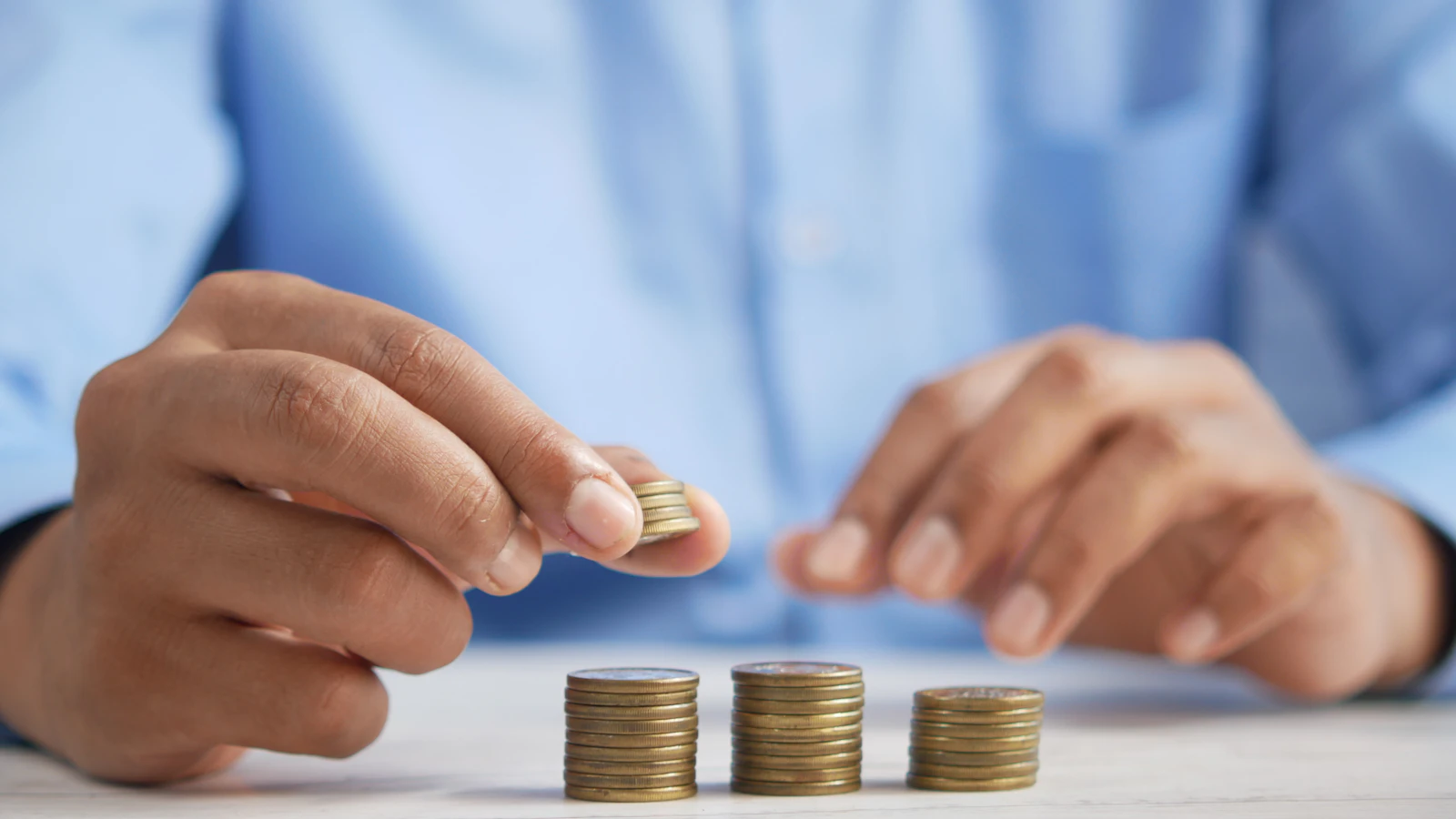 Mains comptant et empilant des pièces lors d'un contrôle de caisse